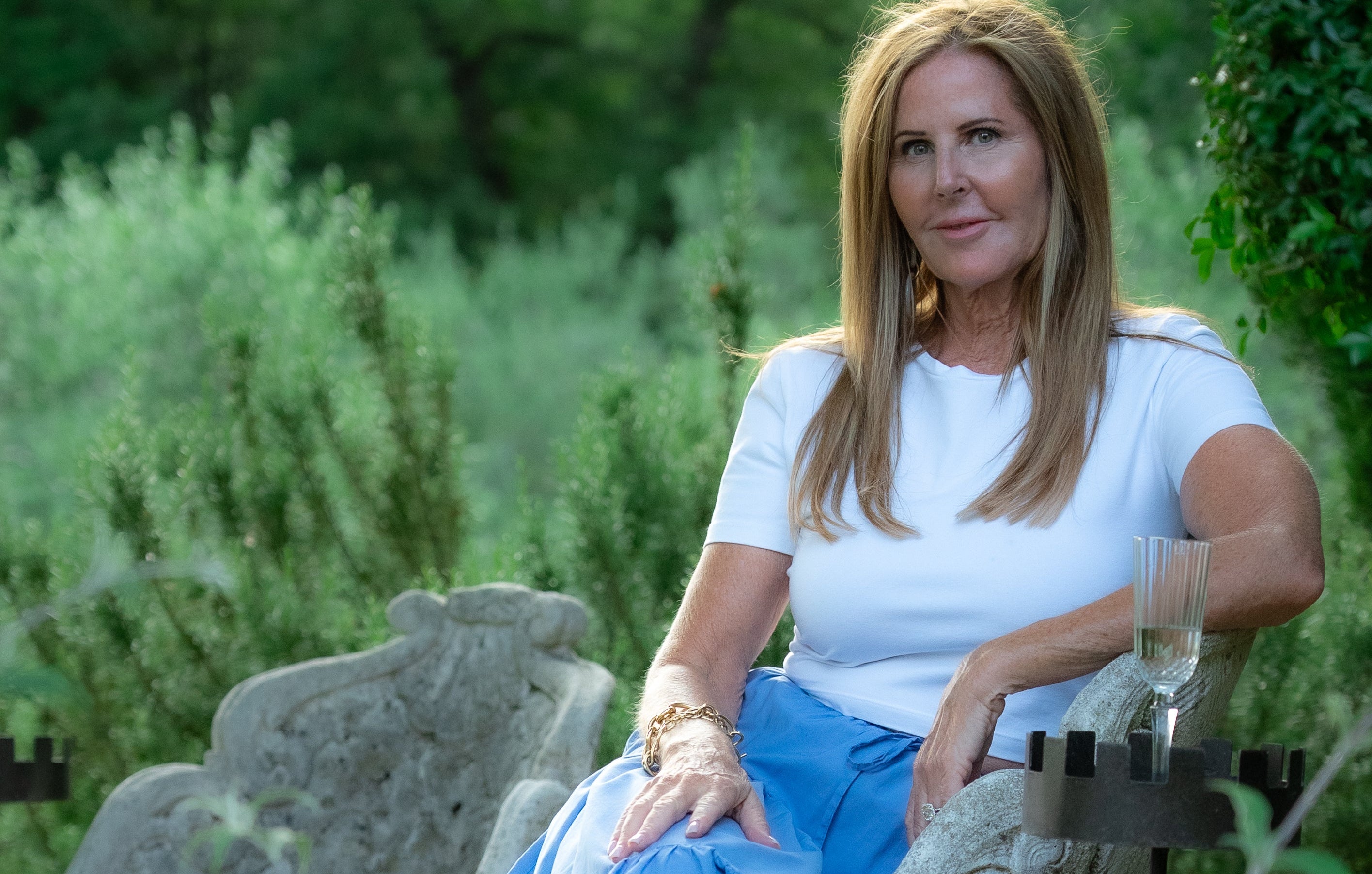 Woman sitting outdoors in a garden setting