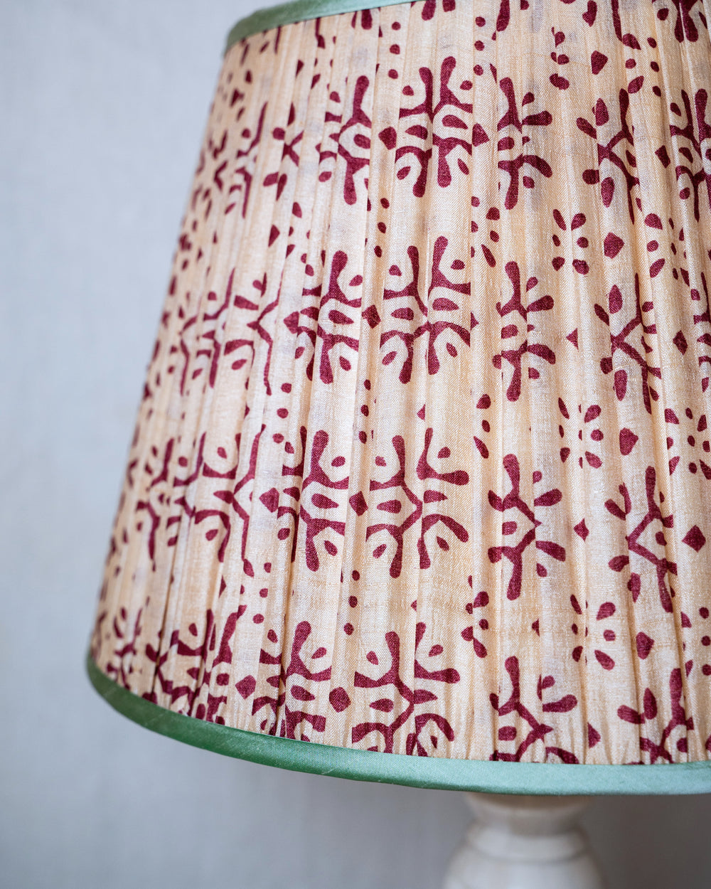 Lamp with a patterned shade on a plain background