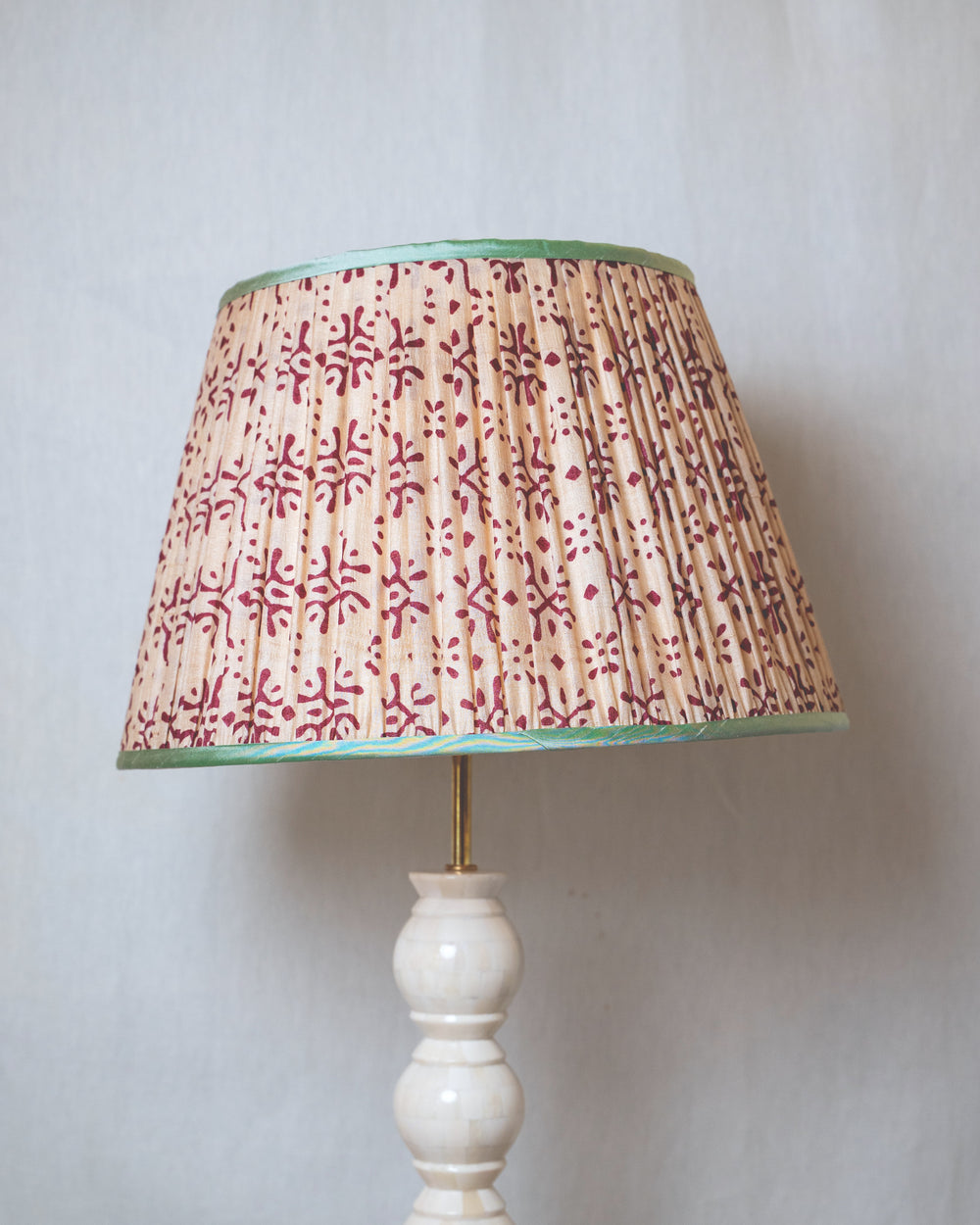 Lamp with a patterned shade on a plain background